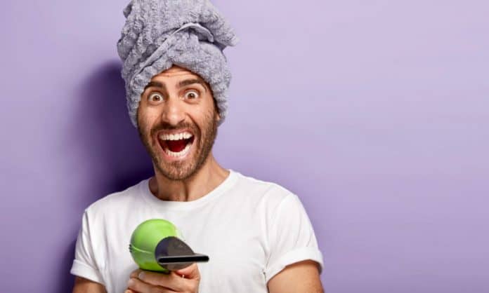 bearded man pointing a blow dryer bearded man pointing a blow dryer
