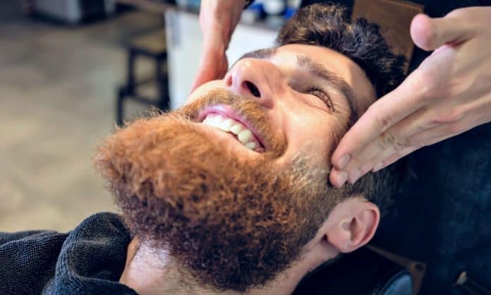man getting his beard exfoliated man getting his beard exfoliated
