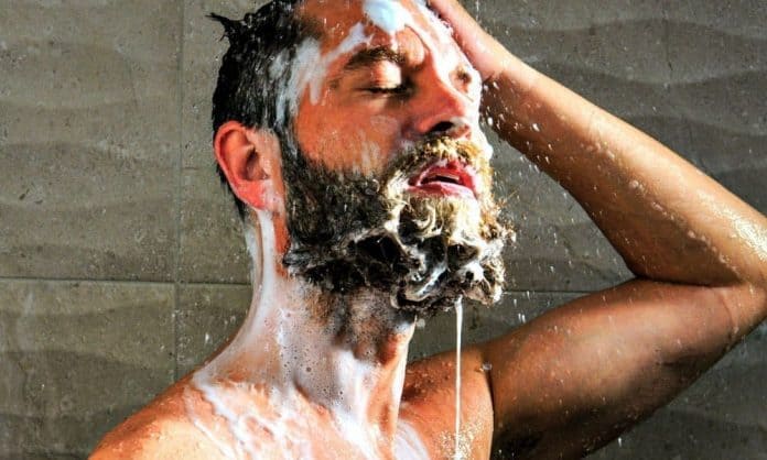man washing his facial hair with shampoo man washing his facial hair with shampoo